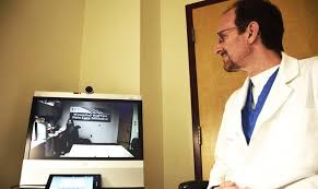 Dr. Spevak looking at computer monitor